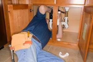 plumbing contractor installs a garbage disposal